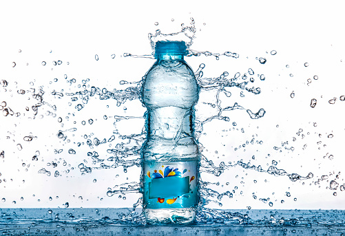 Water splash on water bottle . Small bottle of mineral water
