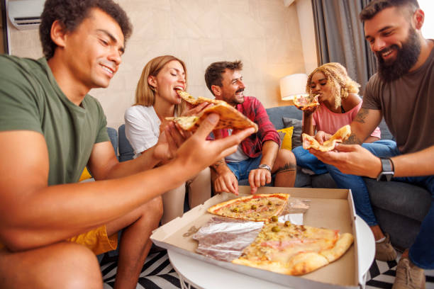 istock Friends eating pizza while spending leisure time at home 1478077168