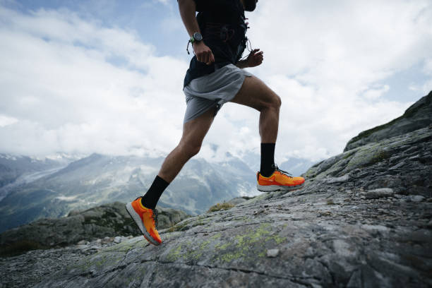 istock Trail runner bounds along mountain trail 1478077698