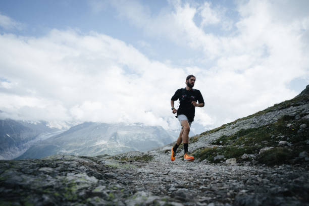 istock Trail runner bounds along mountain trail 1478077699