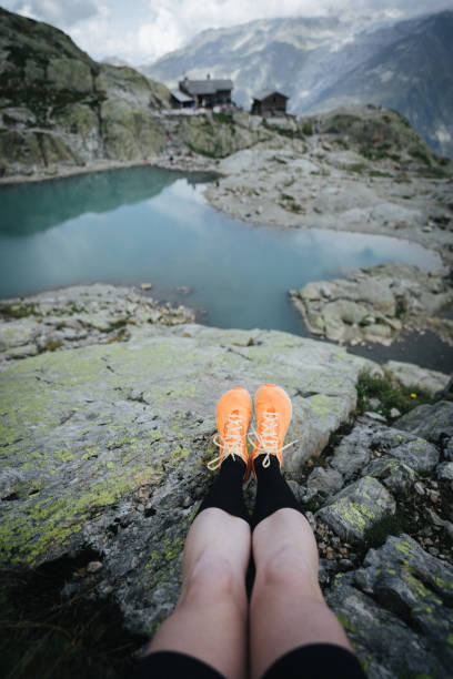 istock POV down trail runners legs to mountain lake below 1478077881