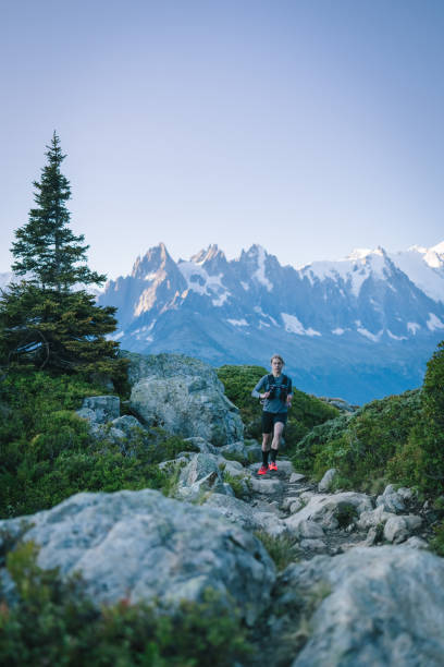 istock Trail runner bounds along mountain trail 1478079856