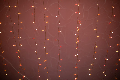 Red garlands. Small light bulbs. LED string lights. Texture Decoration.