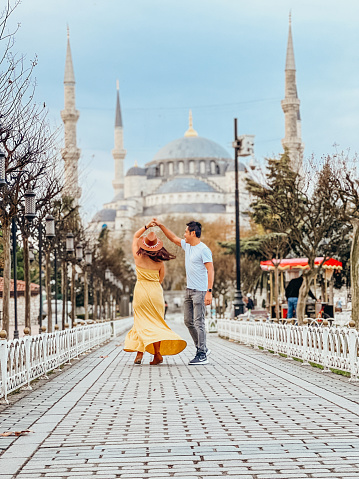 They have fun traveling together, romantic couple. They hold hands in the streets of Istanbul