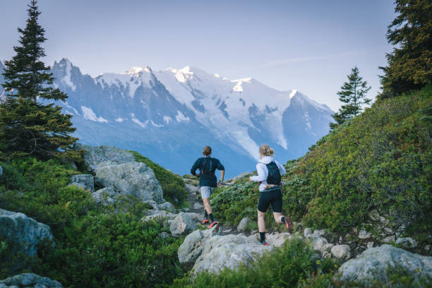 istock Trail runners bound along mountain trail 1478079933