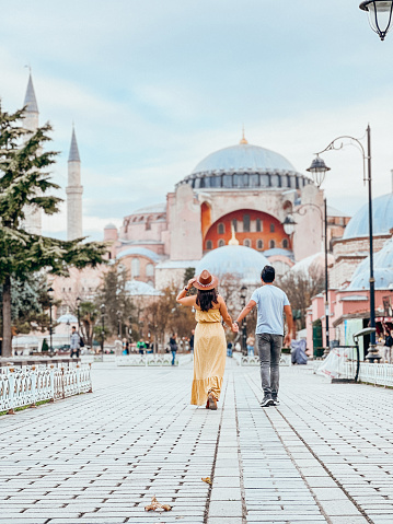 They have fun traveling together, romantic couple. They hold hands in the streets of Istanbul