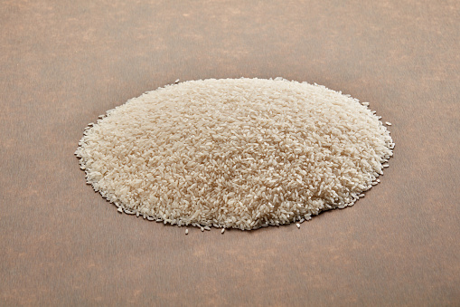 Raw Rice on Brown Table