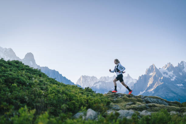 istock Trail runner bounds along mountain trail 1478080493