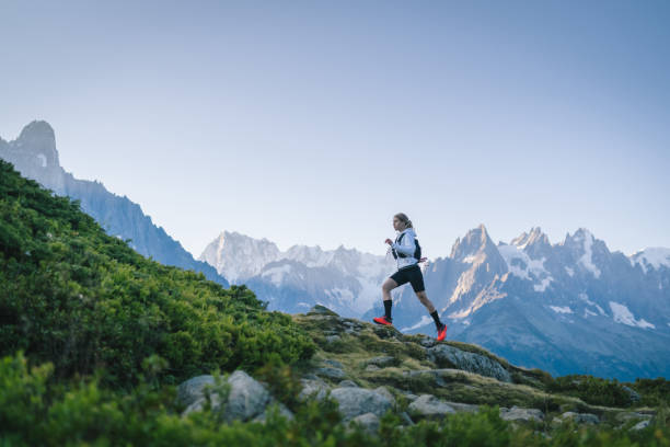 istock Trail runner bounds along mountain trail 1478080583