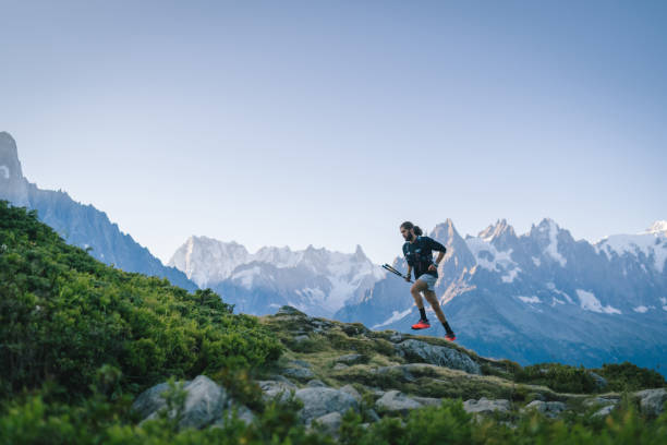 istock Trail runner bounds along mountain trail 1478080584
