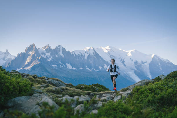 istock Trail runner bounds along mountain trail 1478080585