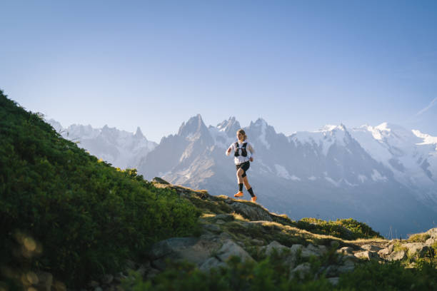 istock Trail runner bounds along mountain trail 1478082323