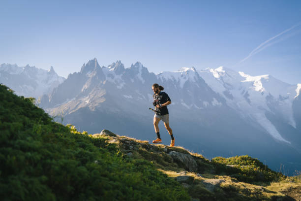 istock Trail runner bounds along mountain trail 1478082400