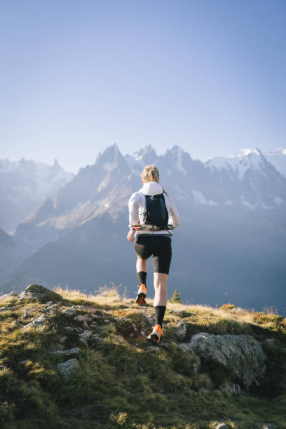 istock Trail runner bounds along mountain trail 1478082463