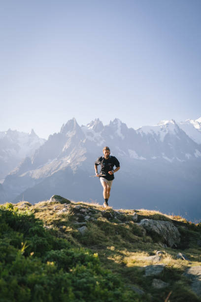 istock Trail runner bounds along mountain trail 1478082518