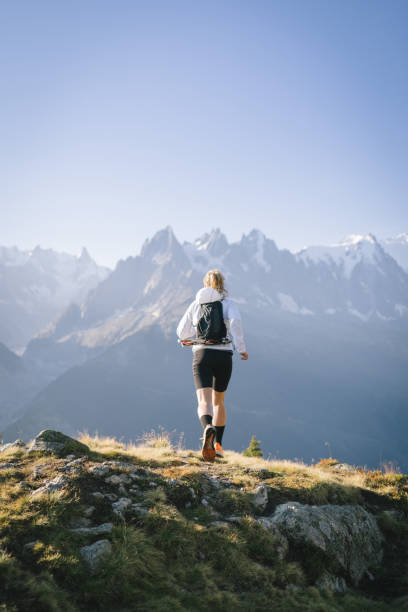 istock Trail runner bounds along mountain trail 1478082520