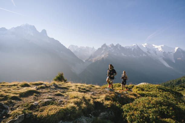 istock Trail runners bound along mountain trail 1478082571