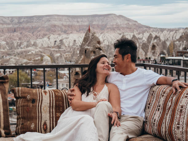 istock Romantic couple in Cappadocia sitting on a rooftop and looking at view 1478086993