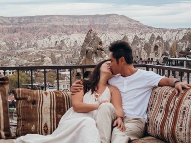 istock Romantic couple in Cappadocia sitting on a rooftop and looking at view 1478087324
