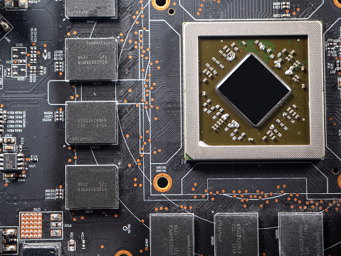 A close-up of a printed circuit board and small components, of which there is a severe shortage in industry