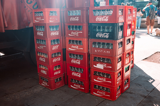 Spain, Barselona, October 14, 2022 Empty bottles from Coca Cola original taste drinks in a red box. Reuse and recycling, care for the environment. The carbonated soft drink