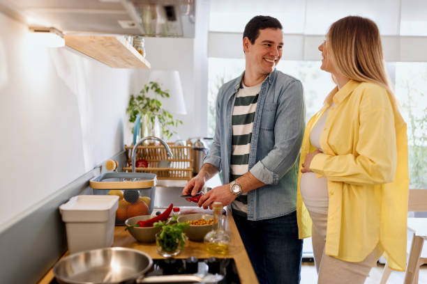 istock Joyful couple preparing lunch at home 1478089790