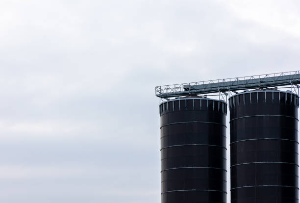 istock A huge, blackm steel grain silo standing in a field. 1478089812