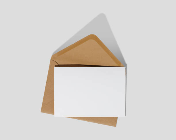 istock Blank white card with kraft brown paper envelope on white background template mockup 1478090893