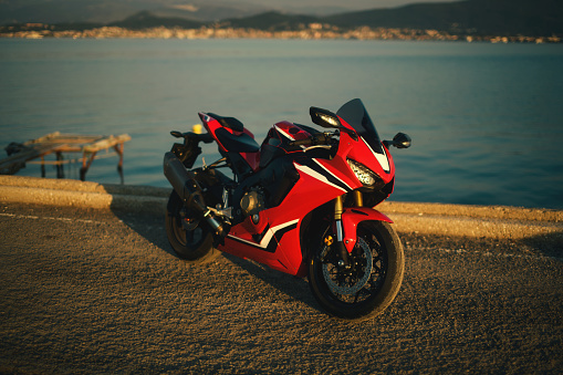 Izmir, Turkey - September 25, 2022: Side view photo of a Honda CBR 1000 RR fireblade racing motorcycle on a sea background