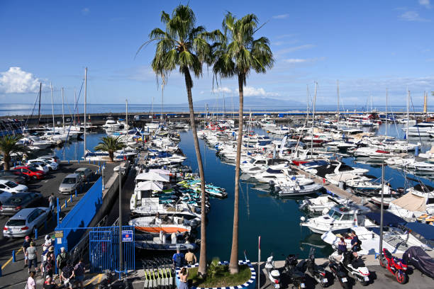 the puerto colón sports harbor on the costa adeje, with the island of gomera in the background. - puerto de sol imagens e fotografias de stock