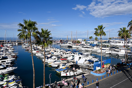 Adeje, Tenerife, Spain, February 5, 2023 - The Puerto Colón sports harbor Playa de las Americas, Tenerife, with the island of Gomera in the background.