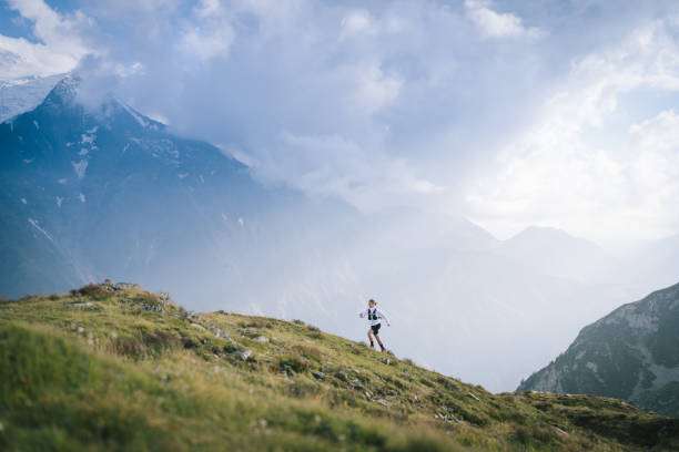 Aerial view of trail runners ascending mountain ridge Chamonix, Haute-Savoie bound woman stock pictures, royalty-free photos & images