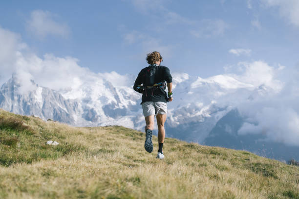 istock Trail runner bounds along mountain trail 1478094819
