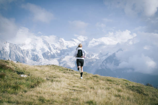 istock Trail runner bounds along mountain trail 1478095028