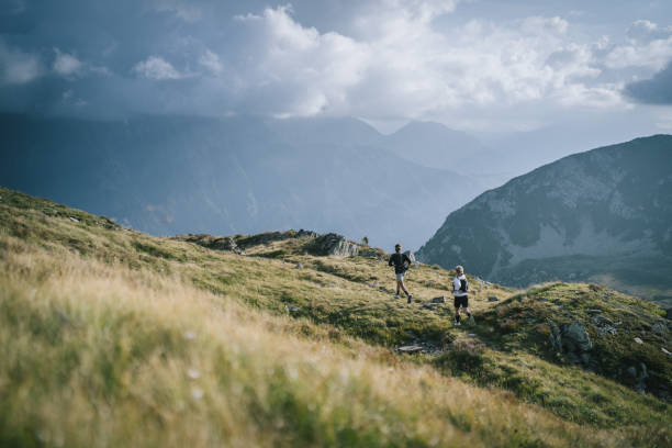 istock Trail runner bounds along mountain trail 1478095033