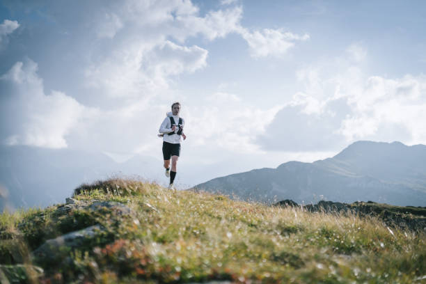 istock Trail runner bounds along mountain trail 1478095163
