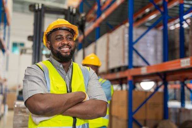 istock African men worker wearing working suite dress and safety helmet at cargo for stack item for shipping.female worker checking the store factory. industry factory warehouse. Inspection quality control. 1478100035