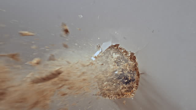 SLO MO LD Bullet making a hole into an MDF board