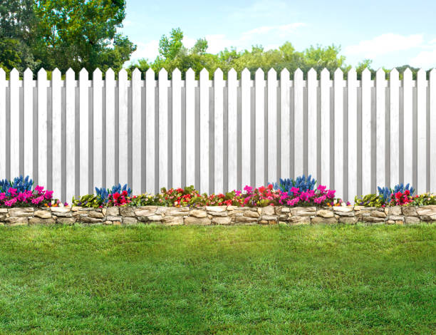 istock Empty backyard with green grass, flowers and a white picket fence 1478105730