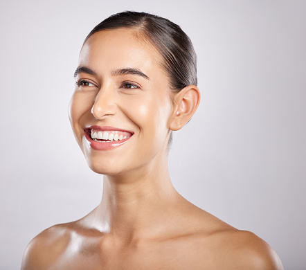 Woman, smile and happy thinking for beauty, skincare wellness and cosmetics dermatology in grey background studio. Model happiness, relax spa facial glow and positive mindset vision for body care.