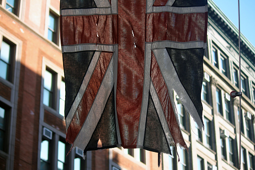 A teared classic Union Jack flag on the streets of New York City