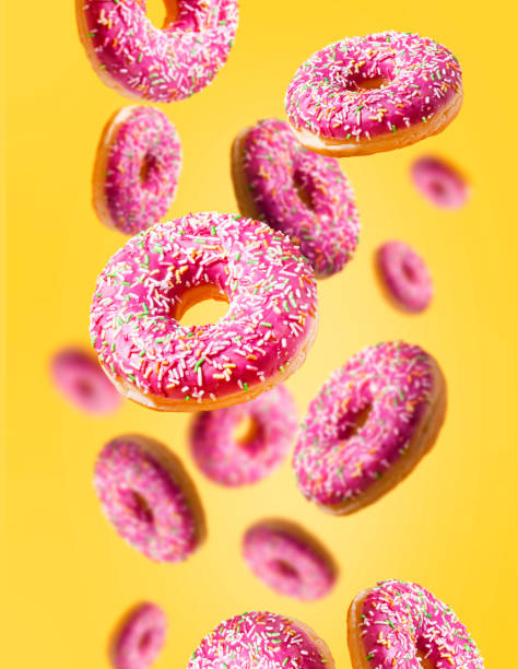 istock Levitating donuts with sprinkles on a yellow background. Modern food concept. Advertisement for a pastry shop or cafe. 1478110050