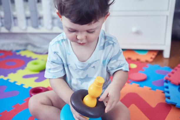 istock Toddler sitting on a  soft children's play mat 1478110097