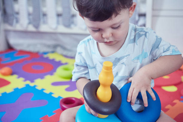 istock Toddler sitting on a  soft children's play mat 1478110185