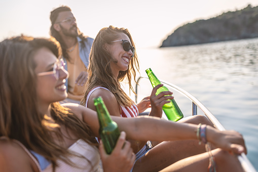 Photo of female friends hangout on speed boat in Aegean sea ,they relax and enjoy drinks.