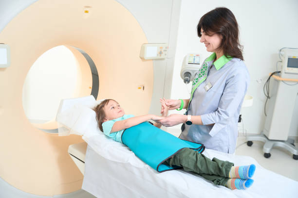 istock Nurse is holding child hands before tomography 1478113576