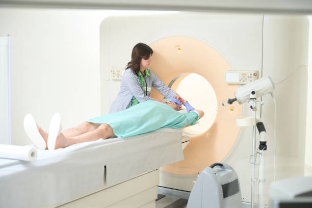 istock Doctor correcting patient hands before MRI scan in clinic 1478113578