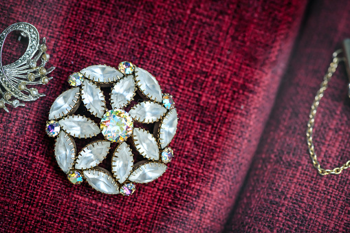 A vertical shot of a man in a suit wearing a beautiful bracelet made of stones