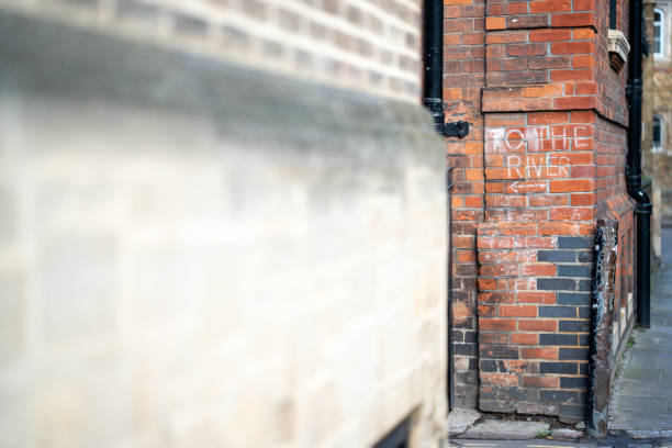 'To the river' chalk signage on the walls of Trinity College, Cambridge.