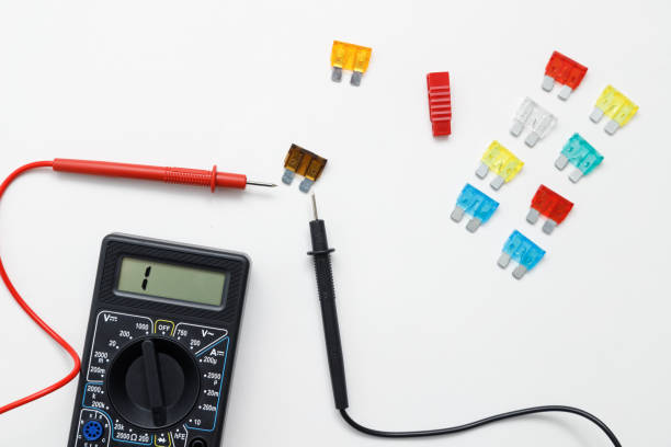 istock Digital multimeter for measuring electrical elements and car fuses on a white background 1478118763